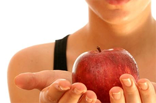 A woman holding an apple